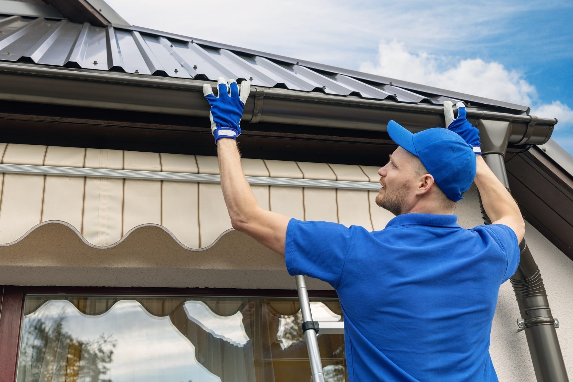 Roofing contractor documenting inspection or installation with tablet on job site