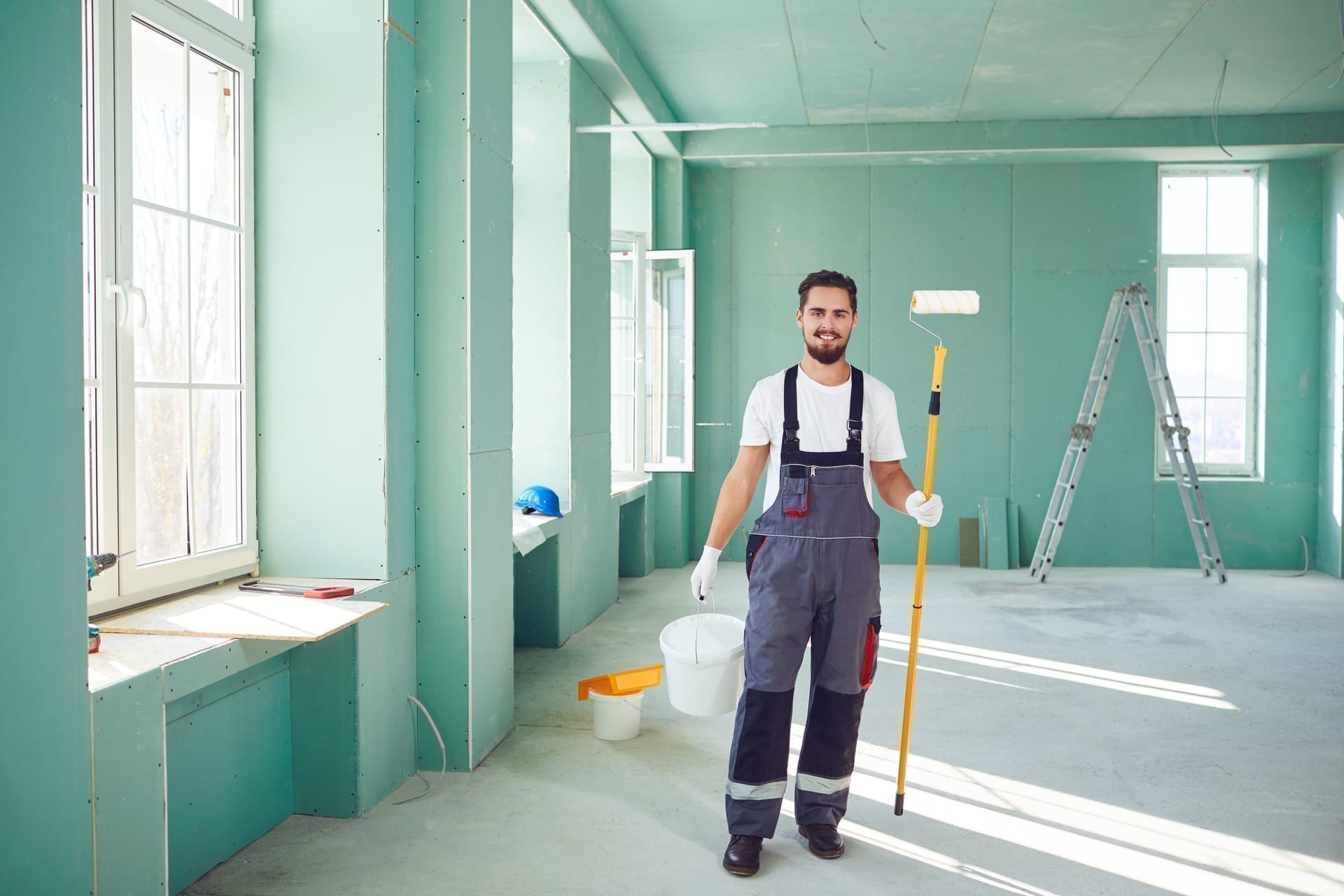 Painting contractor with tablet documenting color and scope at job site