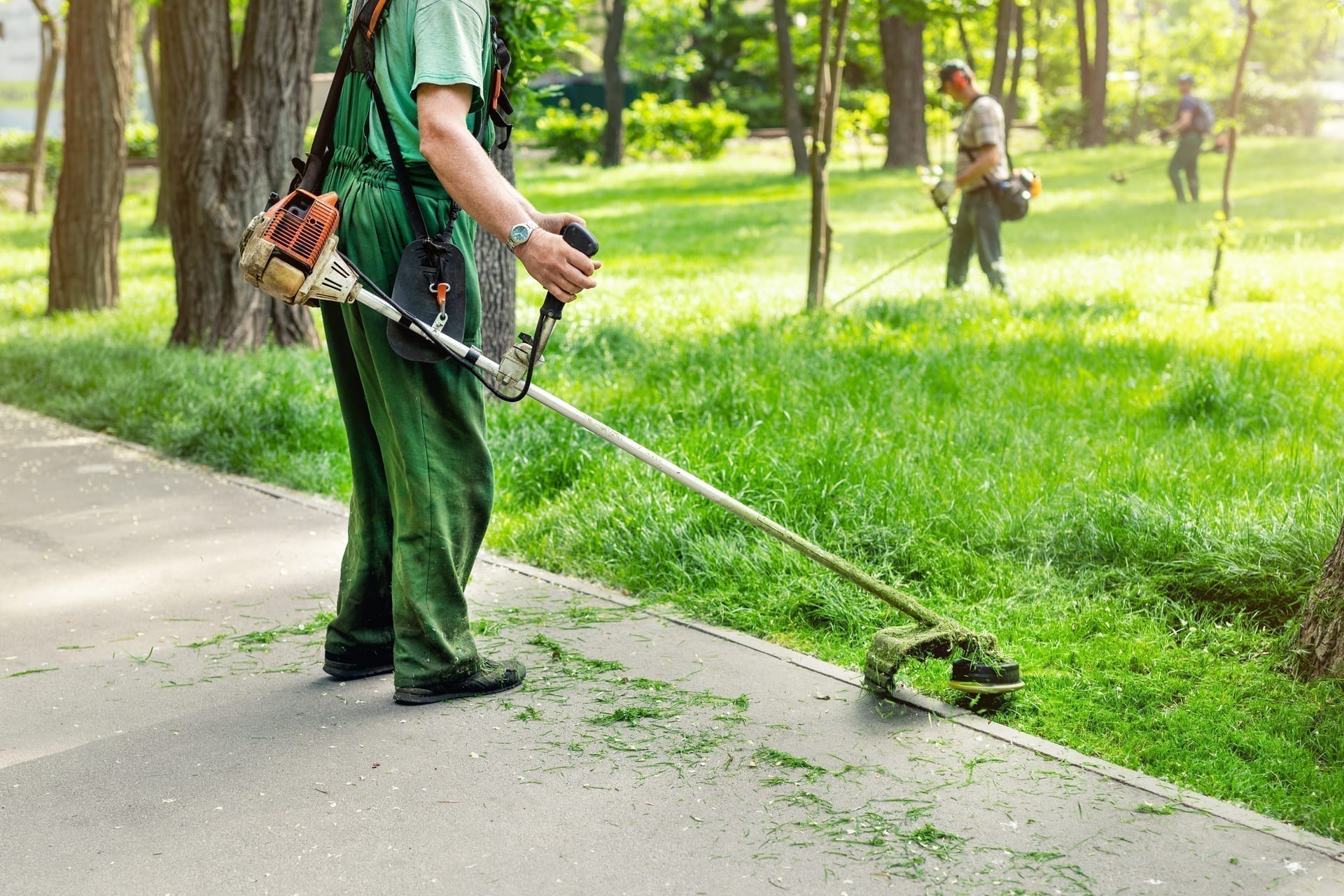 Landscaping crew with tablet checking schedule and route at property